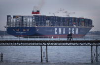 SOUTHAMPTON, ENGLAND - DECEMBER 10: People walk on a pier at Hythe as The Marco Polo, the world's biggest container ship, leaves Southampton on December 10, 2012 in England. On its first visit to Europe, the 54m (177ft) wide and 396m (1299ft) long container ship - which is 51m (167ft) longer than the Queen Mary II - will mostly carry consumer goods for delivery to shops for Christmas. (Photo by Peter Macdiarmid/Getty Images)