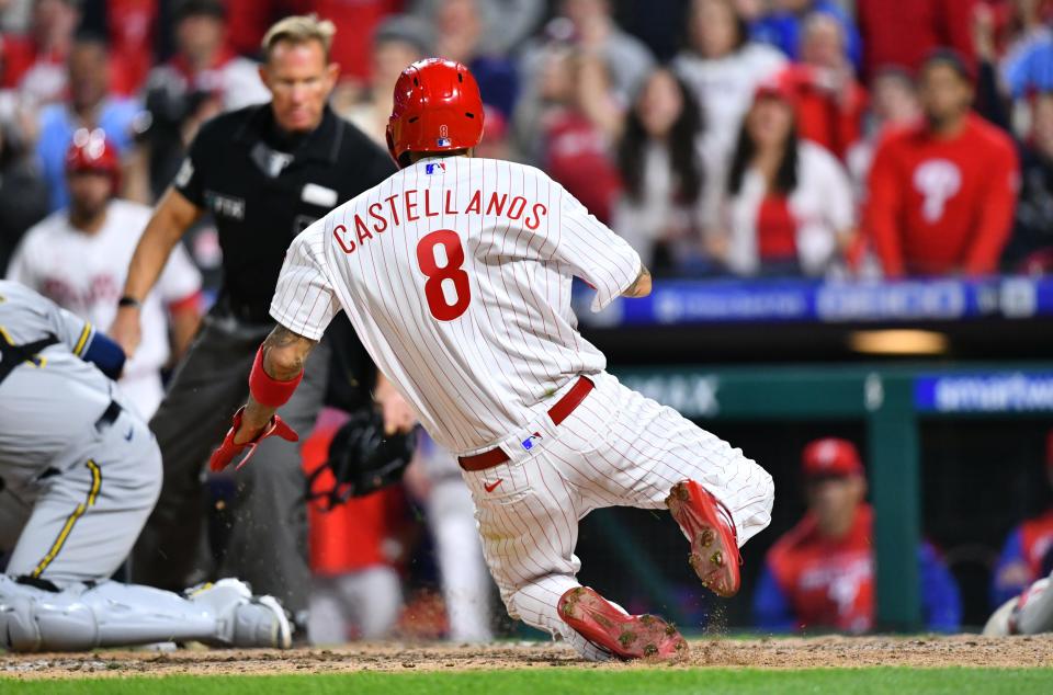 Apr 22, 2022; Philadelphia, Pennsylvania, USA; Philadelphia Phillies designated hitter Nick Castellanos (8) slides to score against the Milwaukee Brewers in the eighth inning at Citizens Bank Park. Mandatory Credit: Kyle Ross-USA TODAY Sports