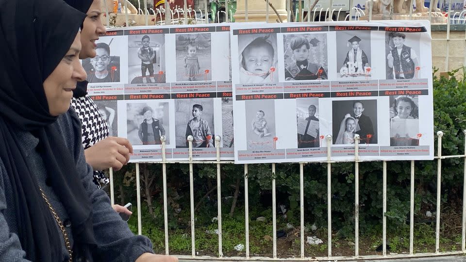 Photos of children killed in Israel's war against Hamas in Gaza are displayed on railings in Al-Manara Square in Ramallah. - Abeer Salman/CNN