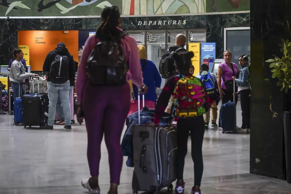 Passengers arrive at LaGuardia Airport, as the Memorial holiday weekend signals the unofficial start of the summer travel season, Thursday May 25, 2023, in New York. (AP Photo/Bebeto Matthews)