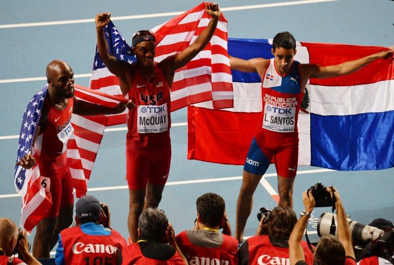 US gold medallist LaShawn Merritt (C) celebrates with his compatriot Tony McQuay and Dominican Republic's Luguelin Santos (R), who finished in second and third places respectively, during the men's 400 metres final at the 2013 IAAF World Championships at the Luzhniki stadium in Moscow on August 13, 2013