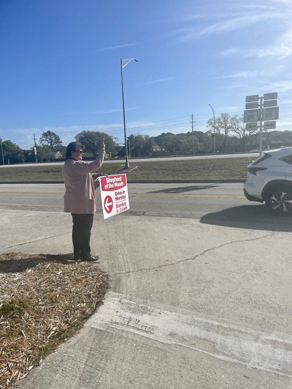 Senior Pastor Kristen Phillips is among Shephard of the Woods church members who spend time on Saturdays and Sundays waving at passersby on Southside Boulevard as a random act of kindness.