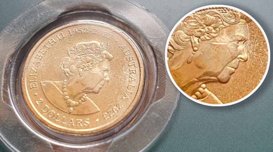 Coin collector set that shows a $2 coin with a dent on the head.