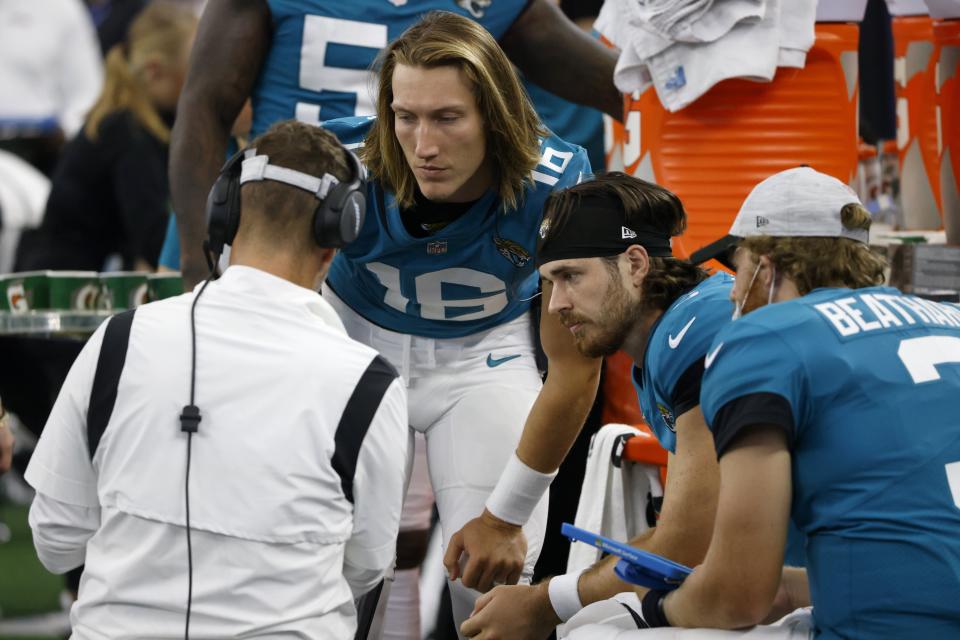 Jaguars quarterbacks (from the left) Trevor Lawrence, Jake luton and C.J. Beathard talk with quarterbacks coach Brian Schottenheimer during a 2021 preseason game at Dallas' AT&T Stadium. The Jaguars return to Dallas for a 2023 preseason game.