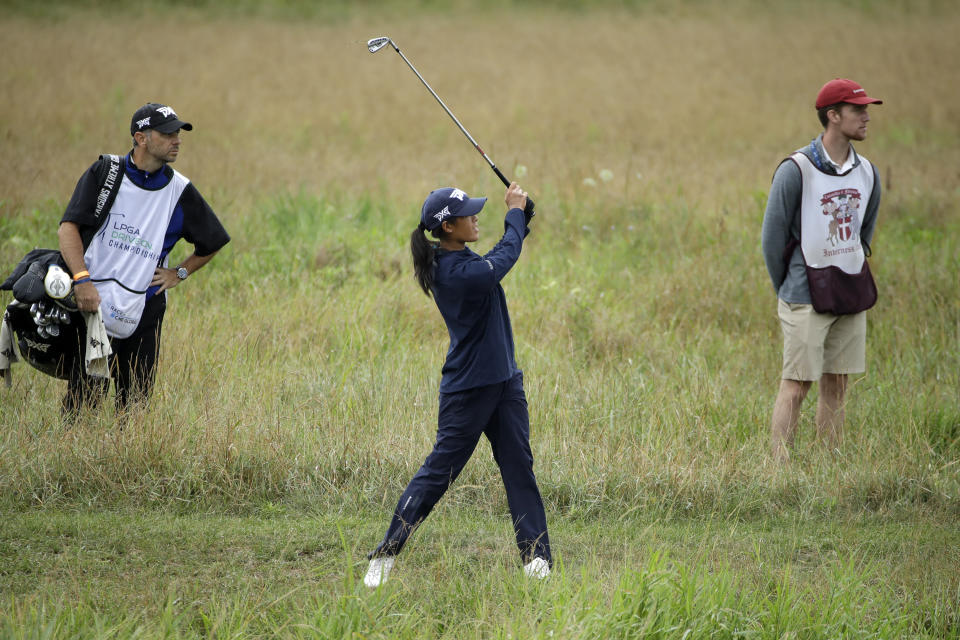 Celine Boutier, center, from France, follows through on her second shot from the rough on the fourth hole during the third and final round of the LPGA Drive On Championship golf tournament Sunday, Aug. 2, 2020, at Inverness Golf Club in Toledo, Ohio. (AP Photo/Gene J. Puskar)