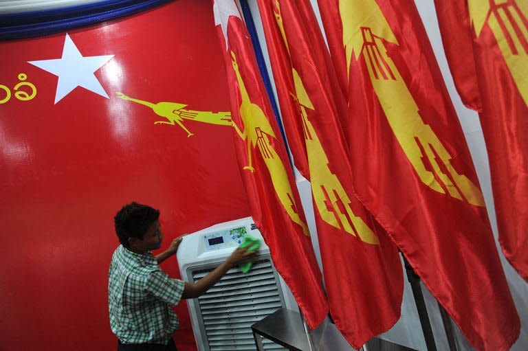 A worker puts the final touches to the venue of the National League for Democracy (NLD) party congress, at the Royal Rose Hall in Yangon, on March 7, 2013. Suu Kyi's long-silenced opposition opened its first ever party conference on Friday, as it sets its sights on the challenges of power in Myanmar after years in the political wilderness