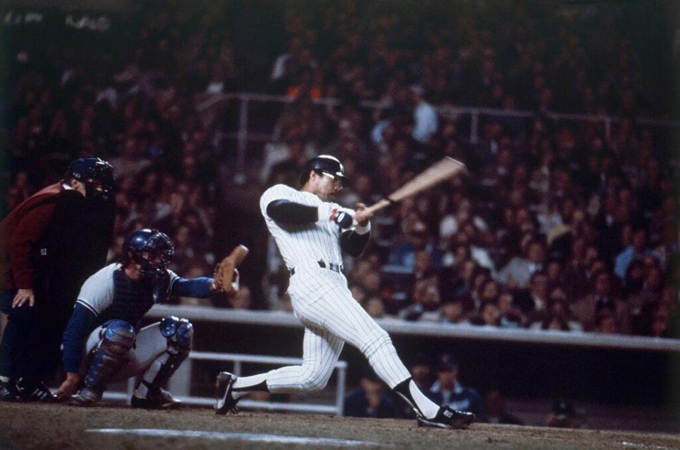 New York Yankees' Reggie Jackson blasts home run No. 3 during the sixth and final game of the World Series at Yankee Stadium in New York on Oct. 18, 1977. (AP Photo)