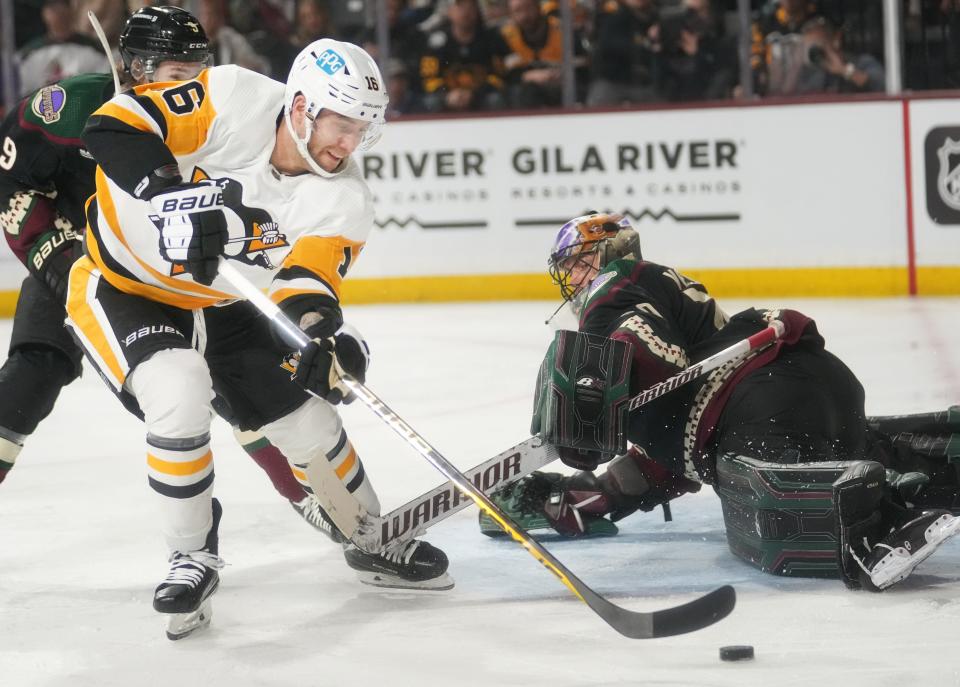 Jan 8, 2023; Tempe, Arizona, USA; Pittsburgh Penguins wing Jason Zucker (16) attempts a shot on goal while skating past Phoenix Coyotes goalie Karel Vejmelka (70) at Mullett Arena. Mandatory Credit: Joe Rondone-Arizona Republic