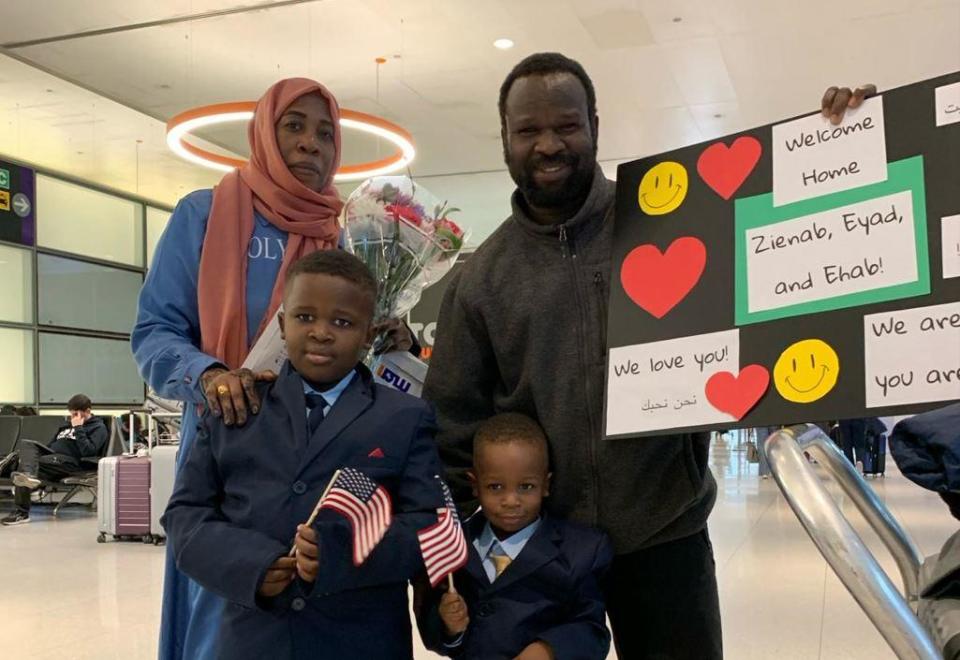 El-Fadel Arbab greets his wife   Zienab Abaker and their two sons, 3-year-old Ehab and 7-year-old Eyad, at Boston's Logan International Airport, in late March 2024, after they arrived from Saudi Arabia. / Credit: Courtesy of El-Fadel Arbab