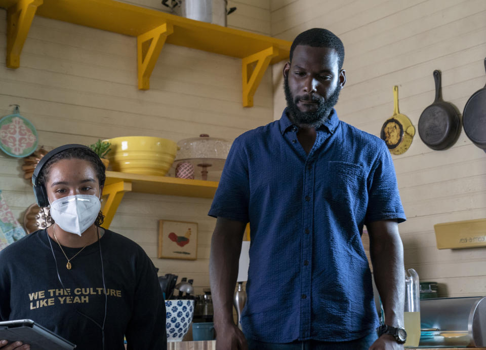 This image released by Warner Bros. Entertainment shows director Cierra Glaude, left, with Kofi Siriboe on the set of “Queen Sugar." When the series debuted in 2016, Glaude worked as a production assistant on the show. Five years later, she’s been promoted to director for season five on the Oprah Winfrey Network series. (Skip Bolen/2020 Warner Bros. Entertainment via AP)