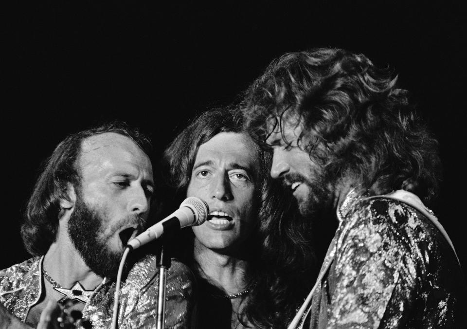 ** FILE ** In this Nov. 6, 1979 file photo, The Bee Gees, from left, Maurice, Robin and Barry Gibb perform in Miami Beach, Fla. Doctors have revived the old disco song "Stayin' Alive" and found that it might actually live up to its name.  At 103 beats per minute, the Bee Gees' sung-in-falsetto tune has almost the perfect rhythm to help jump-start a stopped heart.   (AP Photo/Phil Sandlin, file)