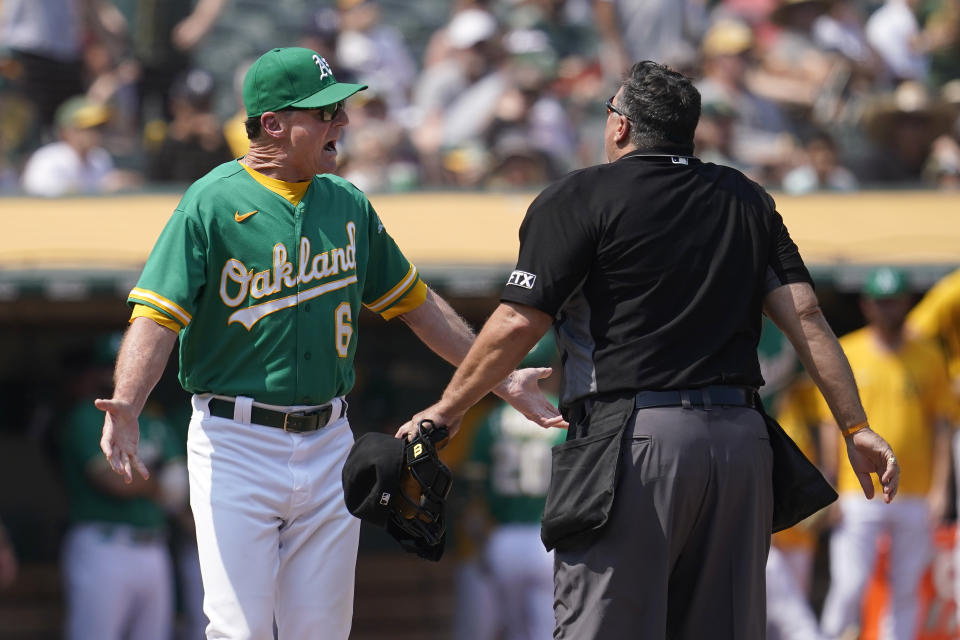 Oakland Athletics manager Bob Melvin, left, reacts after being thrown out by umpire Tony Randazzo, right, during the third inning of a baseball game against the New York Yankees in Oakland, Calif., Saturday, Aug. 28, 2021. (AP Photo/Jeff Chiu)