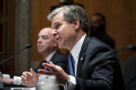 Secretary of Homeland Security Alejandro Mayorkas, left, and FBI Director Christopher Wray, testify before a Senate Homeland Security and Governmental Affairs Committee hearing to discuss security threats 20 years after the 9/11 terrorist attacks, Tuesday, Sept. 21, 2021 on Capitol Hill in Washington. (Greg Nash/Pool via AP)