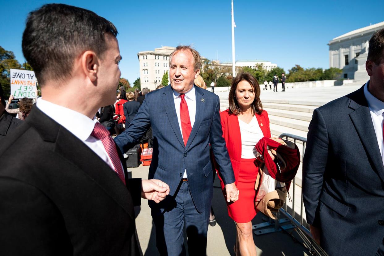 Texas Attorney General Ken Paxton and his wife Angela leave after speaking to pro-life activists outside the Supreme Court after the court heard two challenges to Texass new abortion law on Monday, Nov. 1, 2021.