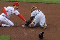 Cleveland Indians' Jose Ramirez, right, steals second base ahead of a tag by Cincinnati Reds' Eugenio Suarez, left, during the fifth inning of a baseball game in Cincinnati, Saturday, April 17, 2021. (AP Photo/Aaron Doster)