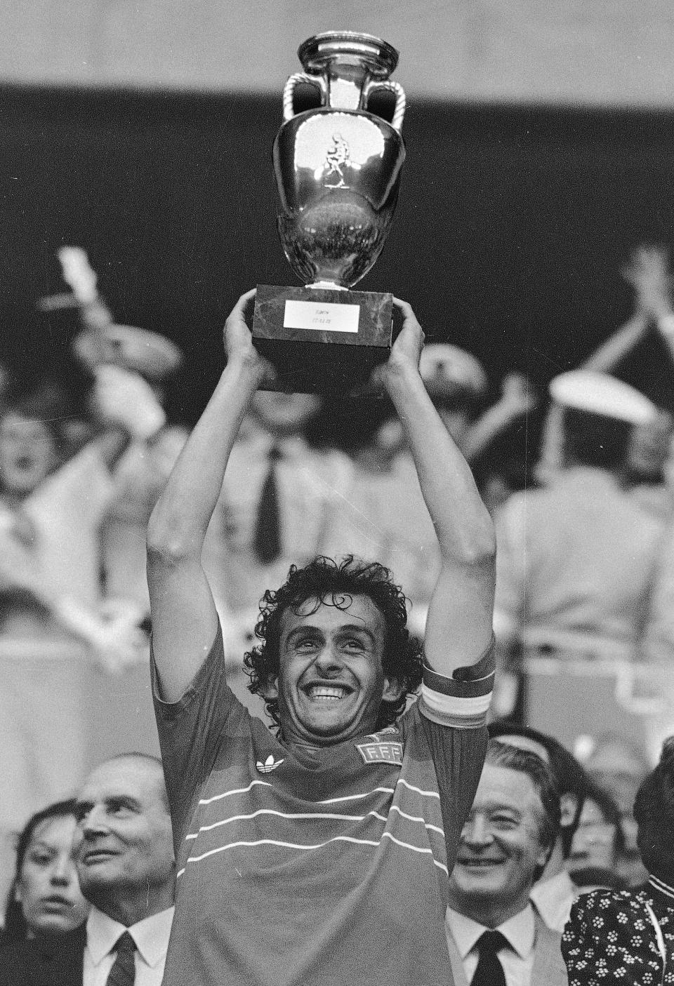 FILE - In this file b/w photo dated June 27, 1984 French team captain Michel Platini holds high the winner's cup after France beat Spain, 2-0, in the final match of the European Soccer Championship at the Parc des Princes stadium in Paris. Affectionately nicknamed “Le Roi” (The King), Michel Platini bestrode the soccer field with inimitable elegance as the world’s best player of the early 1980s, but his lofty reputation seems to have been tainted.(AP Photo, FILE)