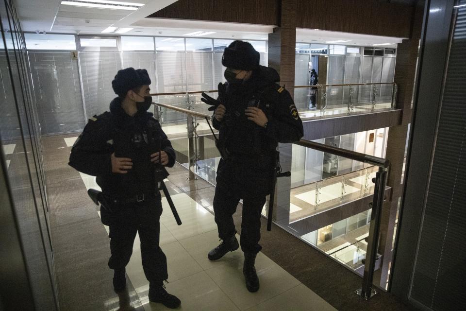 Police stand guard at the Foundation for Fighting Corruption office in Moscow, Russia, Wednesday, Jan. 27, 2021. Police are searching the Moscow apartment of jailed Russian opposition leader Alexei Navalny, another apartment where his wife is living and two offices of his anti-corruption organization. Navalny's aides reported the Wednesday raids on social media. (AP Photo/Pavel Golovkin)