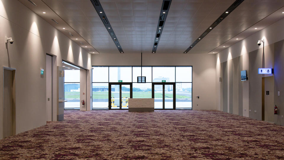 <p>Departing passengers will pass through these doors at the new Seletar Airport passenger terminal to get to their flights. (PHOTO: Yahoo News Singapore / Dhany Osman) </p>