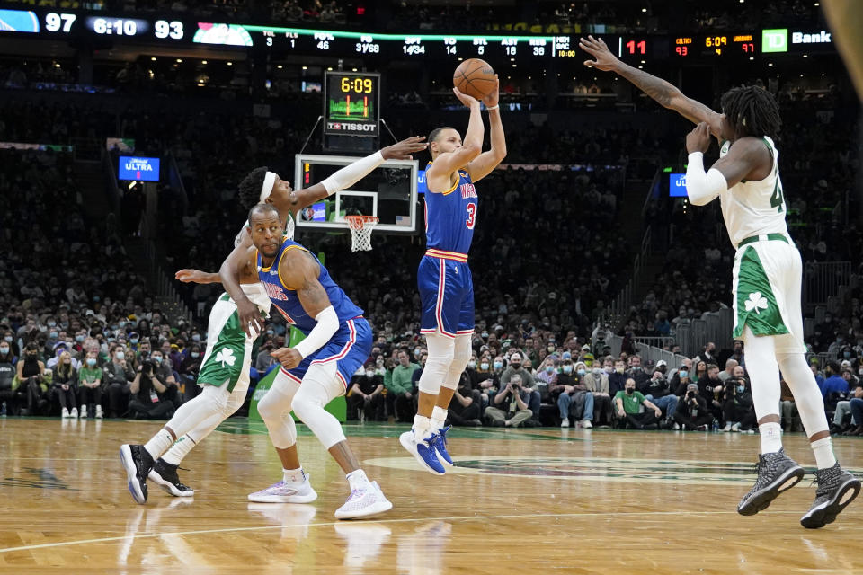 Golden State Warriors guard Stephen Curry (30) shoots a three-point shot off of a screen by teammate Andre Iguodala as Boston Celtics guard Josh Richardson, left, and Celtics center Robert Williams III (44) try to block the shot during the second half of an NBA basketball game, Friday, Dec. 17, 2021, in Boston. (AP Photo/Mary Schwalm)