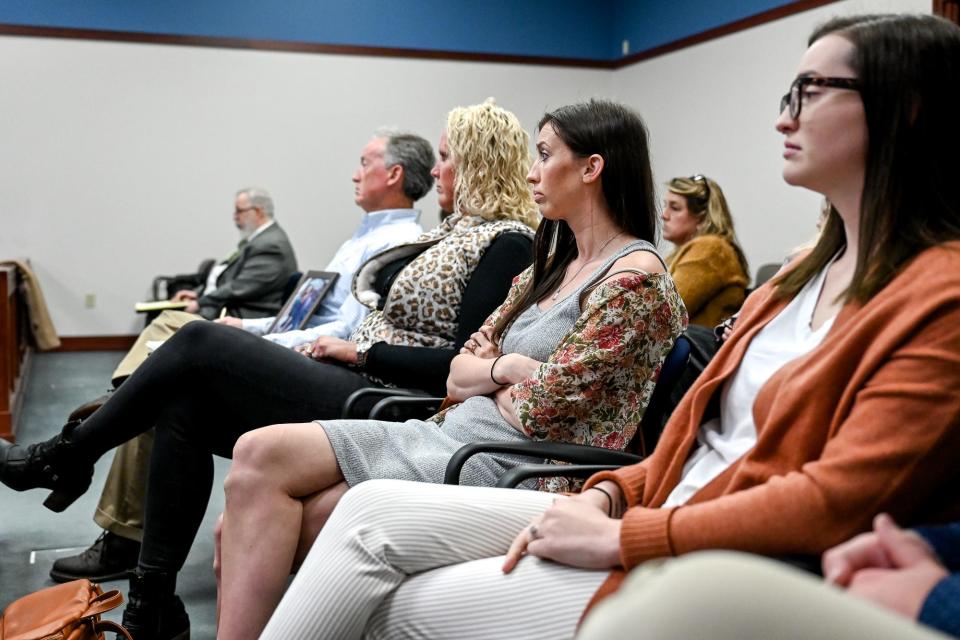 Sister of Joseph Small, Sarah, center, and Anna, right, listen during the trial on Monday, April 4, 2022, in Ingham County Circuit Court Judge Clinton Canady III's courtroom in Lansing for the man charged with selling drugs to their brother before his death.