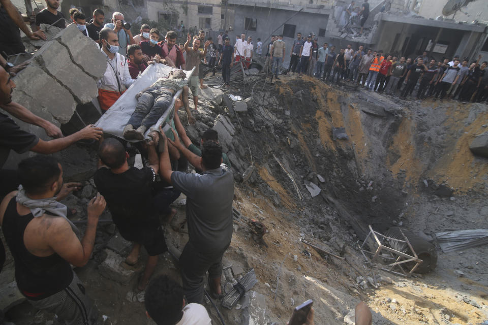 Palestinians pull a boy from the rubble after an Israeli strike on the Zaroub family house in Rafah, Gaza Strip, Tuesday, Oct.24, 2023. (AP Photo/Hatem Ali)