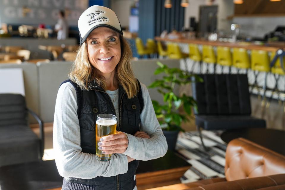 Sue Rigler, owner, poses for a portrait at Hundred Mile Brewing Co. Friday, Dec. 2, 2022, in Tempe.