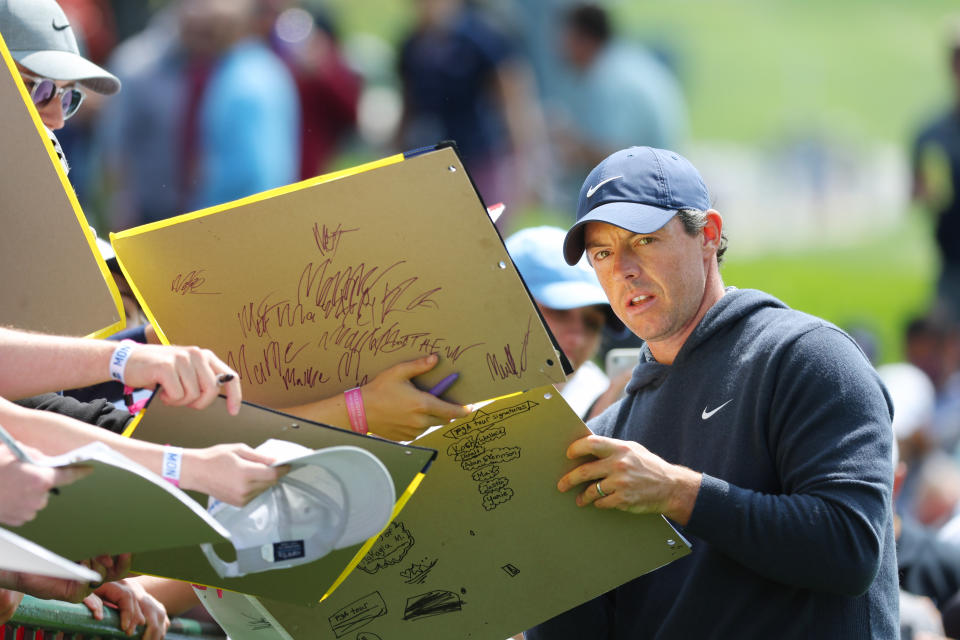 ROCHESTER, NEW YORK - MAY 15: Rory McIlroy of Northern Ireland signs his autograph for a fan during a practice round prior to the 2023 PGA Championship at Oak Hill Country Club on May 15, 2023 in Rochester, New York. (Photo by Kevin C. Cox/Getty Images)