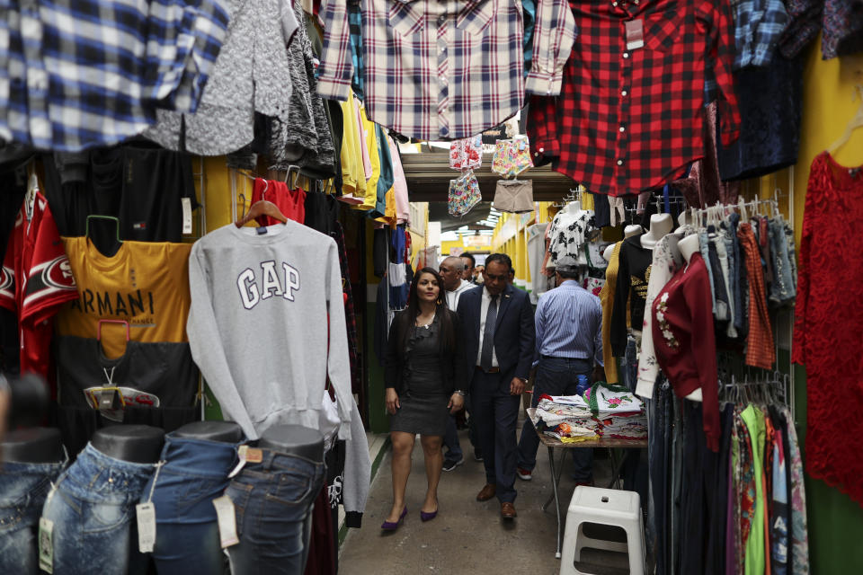 In this Feb. 10, 2020 photo, Mayor Maria del Carmen Ortiz tours the local market in Apaseo El Alto, Guanajuato state, Mexico, following an event to inaugurate renovated sections of the market. Ortiz took office after her husband, the leading candidate to fill the office was shot to death in 2018. Between late 2019 and early 2020, her police chief, a town councilman and a police officer were shot to death. "2018, 2019 were terrible years," she concedes. (AP Photo/Rebecca Blackwell)