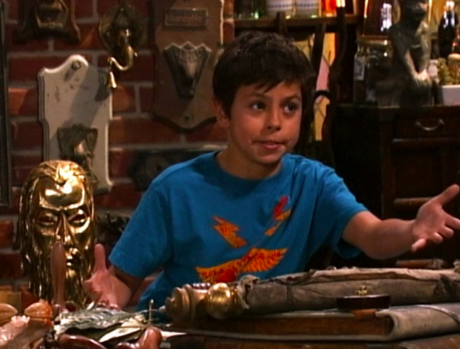 Jake T. Austin as Max Russo in a graphic t-shirt