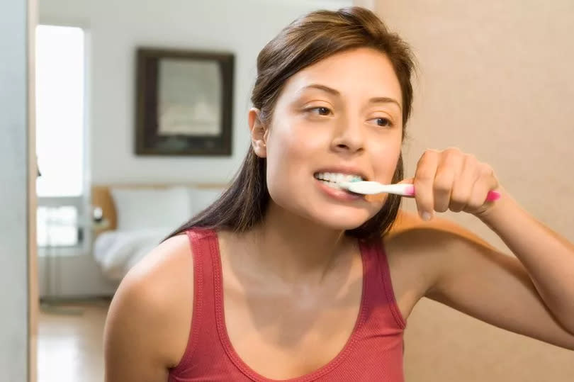 A woman brushing her teeth