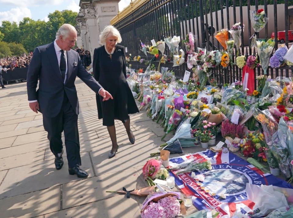 King Charles III and the Queen view tributes left outside Buckingham Palace (Yui Mok/PA) (PA Wire)
