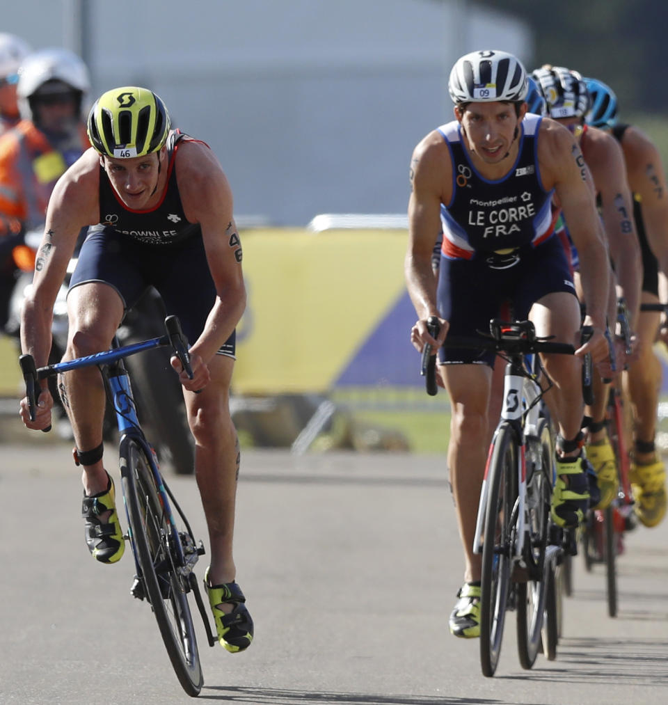 Alistair Brownlee of Great Britain, left, and Pierre Le Corre of France, right, participate in the cycling discipline of the men's triathlon finals at Strathclyde Country Park during the European Championships in North Lanarkshire, Scotland, Friday, Aug. 10, 2018. (AP Photo/Darko Bandic)