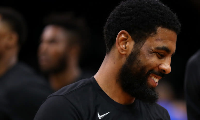 A closeup of a smiling Kyrie Irving.