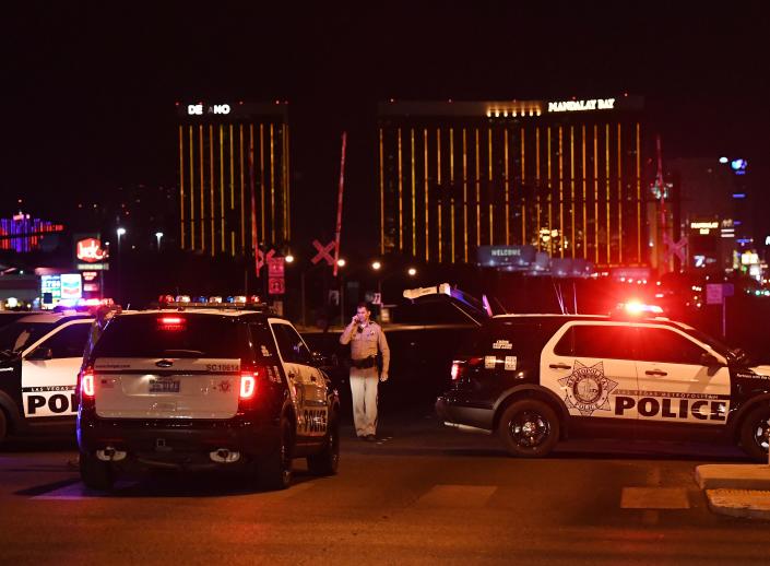 Police form a perimeter around the road leading to the Mandalay Bay Hotel (background) after a gunman killed more than 50 people and wounded more than 800 others at the festival on Oct. 1, 2017. (Photo: Mark Ralston/AFP/Getty Images)