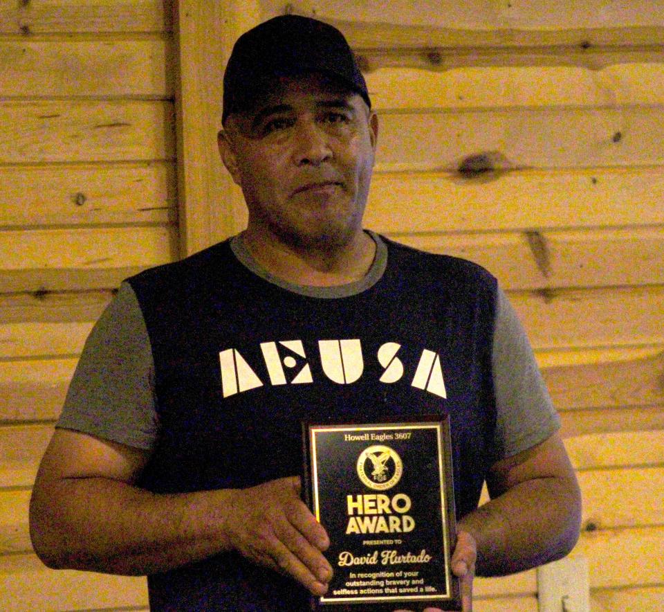 David Hurtado received a heroism award from the Howell Eagles Club on Saturday, May 18, for running back into a flaming condo to save his daughter.