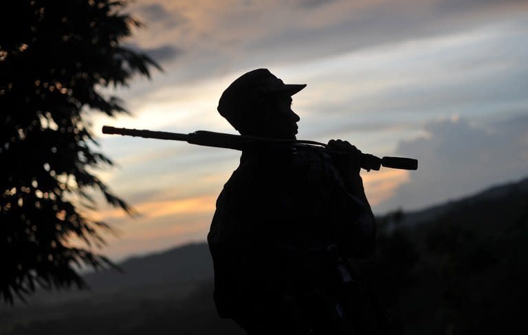 A rebel fighter is seen on patrol outside a town in Myanmar's northern Kachin state, on September 22, 2012. Kachin rebels cast doubt on Saturday over a Myanmar government pledge to end a military offensive after weeks of intense fighting that sparked international concern amid reports of fresh shelling