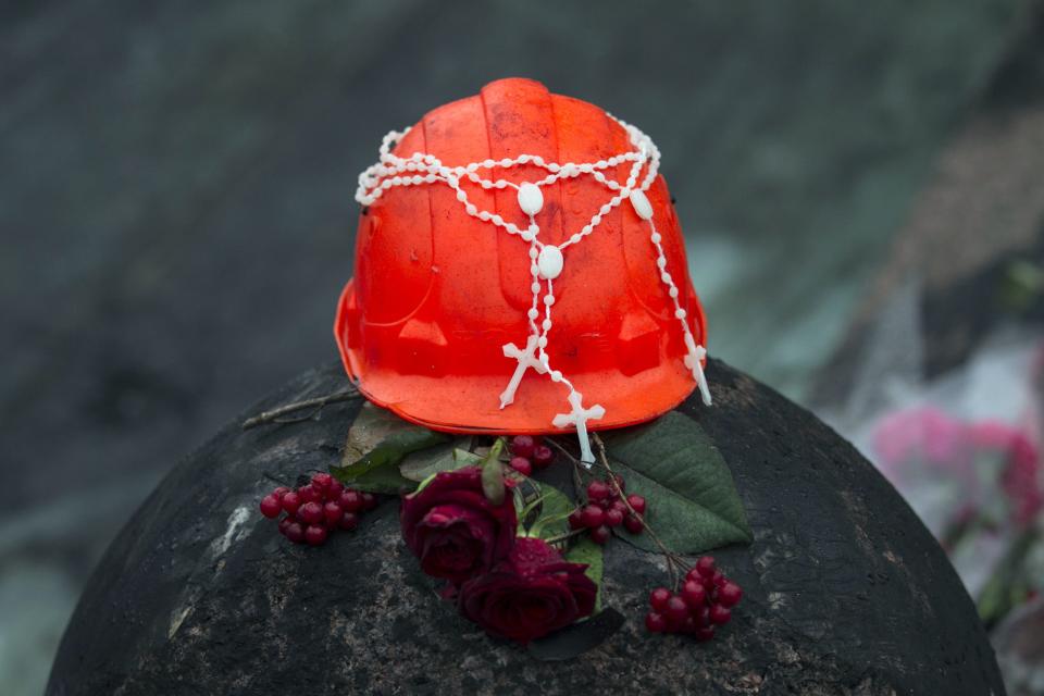 Crosses are placed on a helmet at a makeshift memorial in the Independence Square in Kiev