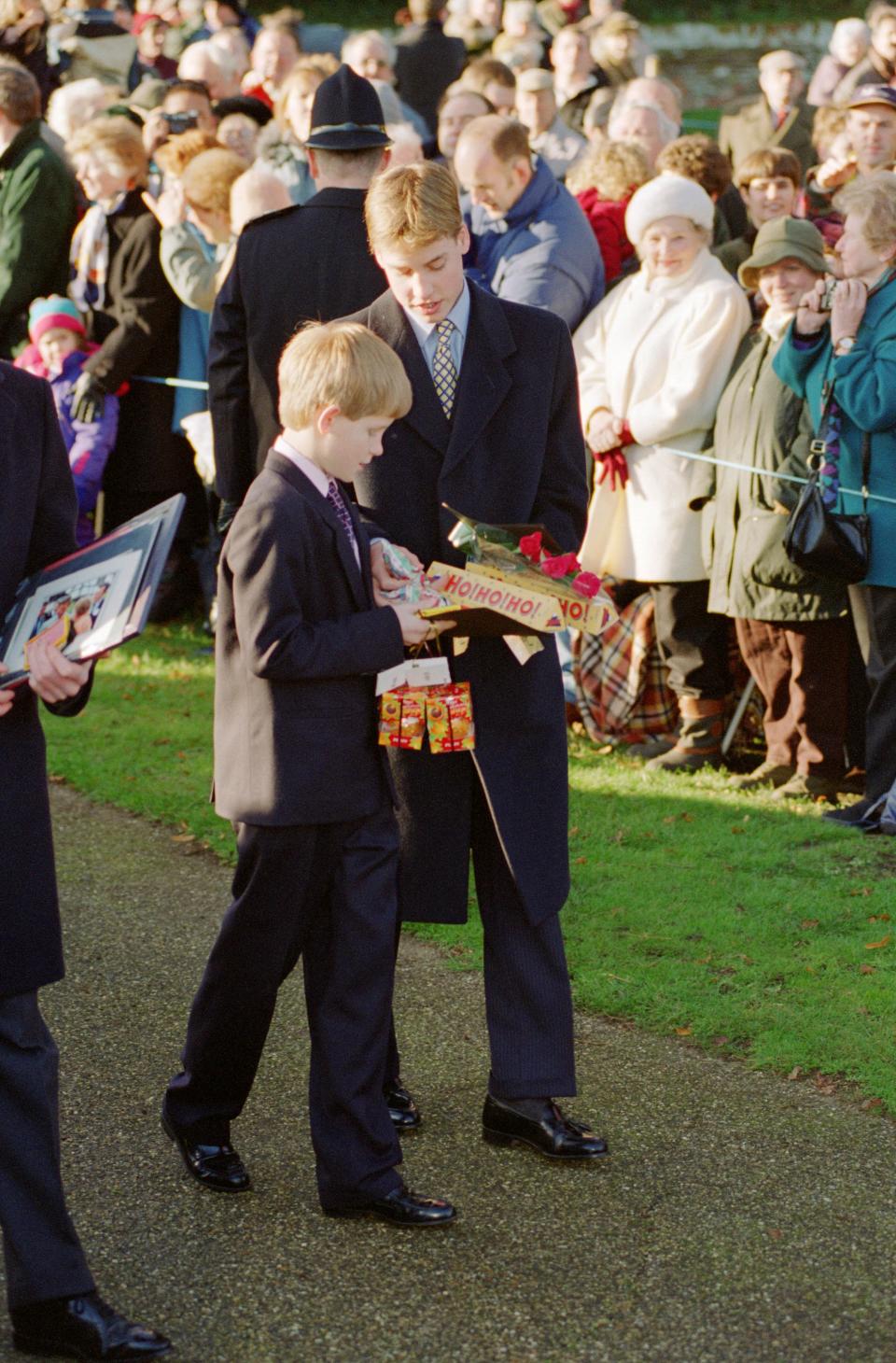 A young Prince Harry and Prince William inspect presents they received from the crowd in 1996. Photo: Getty Images