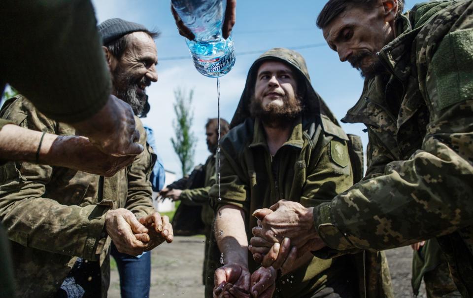 Ukrainian military members wash hands after being returned from captivity in Donetsk region. - Global Images Ukraine/Getty Images Europe