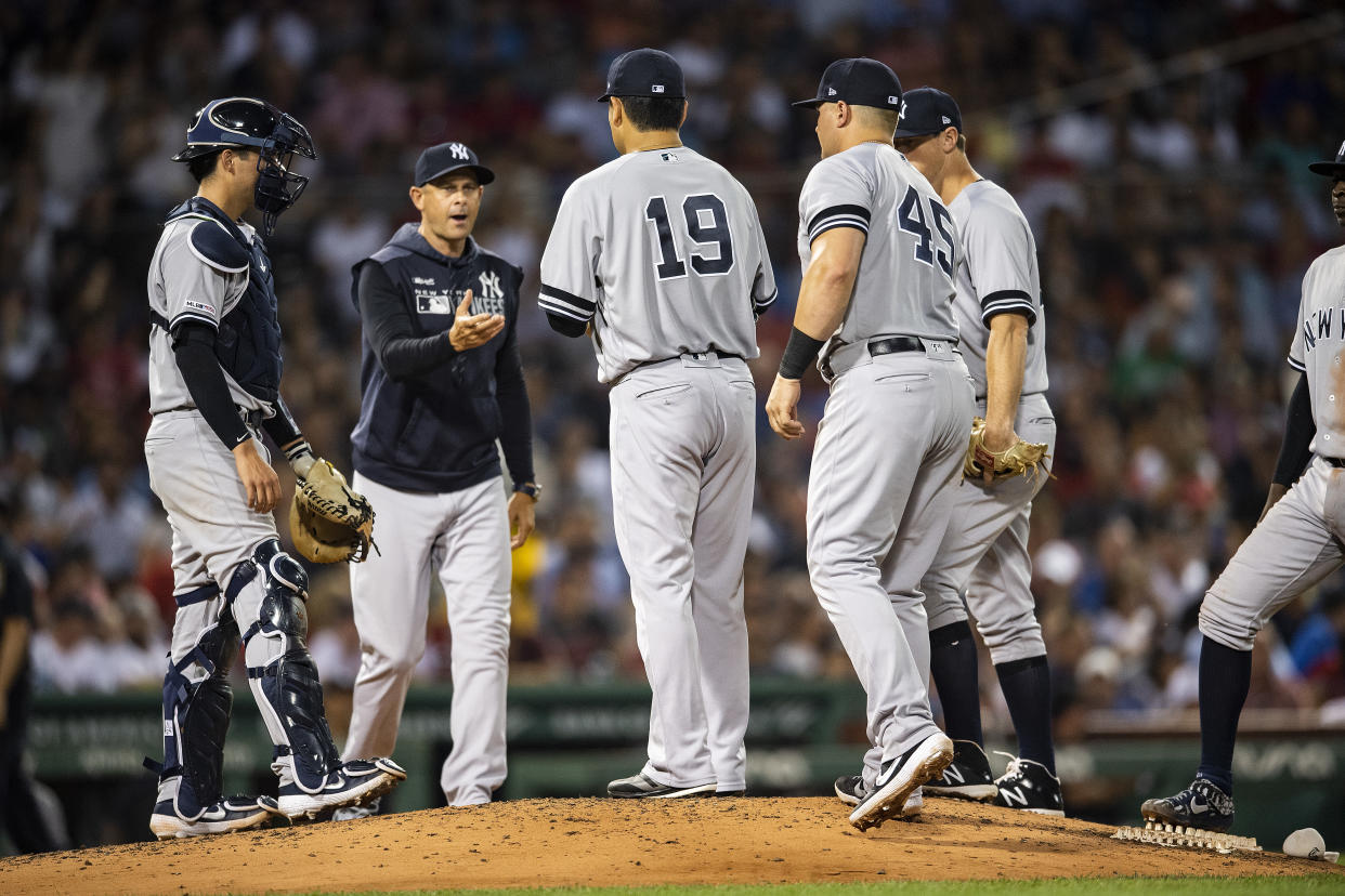 BOSTON, MA - JULY 25: Masahiro Tanaka #19 of the New York Yankees hands the ball to manager Aaron Boone as he exits the game during the fourth inning of a game against the New York Yankees on July 25, 2019 at Fenway Park in Boston, Massachusetts. (Photo by Billie Weiss/Boston Red Sox/Getty Images)