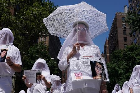 Participants take part in the LGBT Pride March in the Manhattan borough of New York City, U.S., June 25, 2017. REUTERS/Carlo Allegri