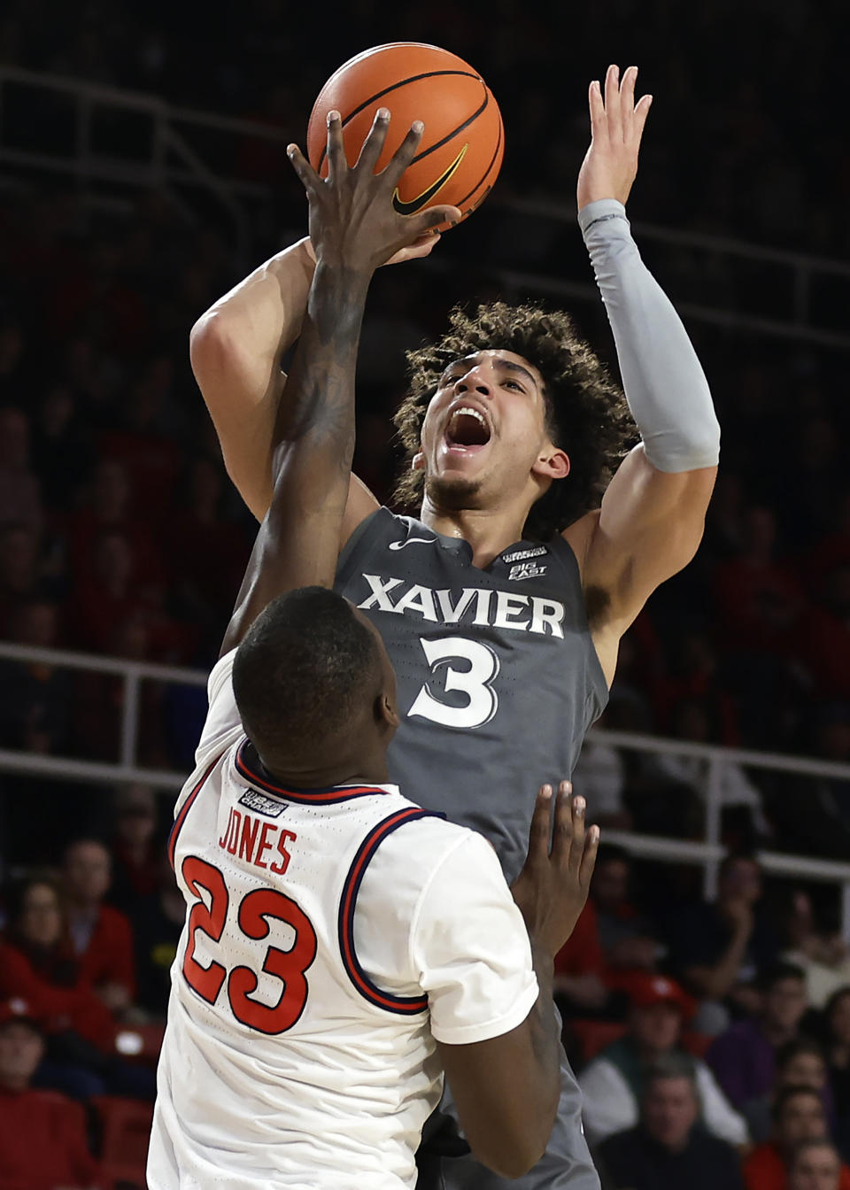 Xavier guard Colby Jones (3) shoots over St. John's forward David Jones during the first half of an NCAA college basketball game Wednesday, Dec. 28, 2022, in New York. (AP Photo/Adam Hunger)