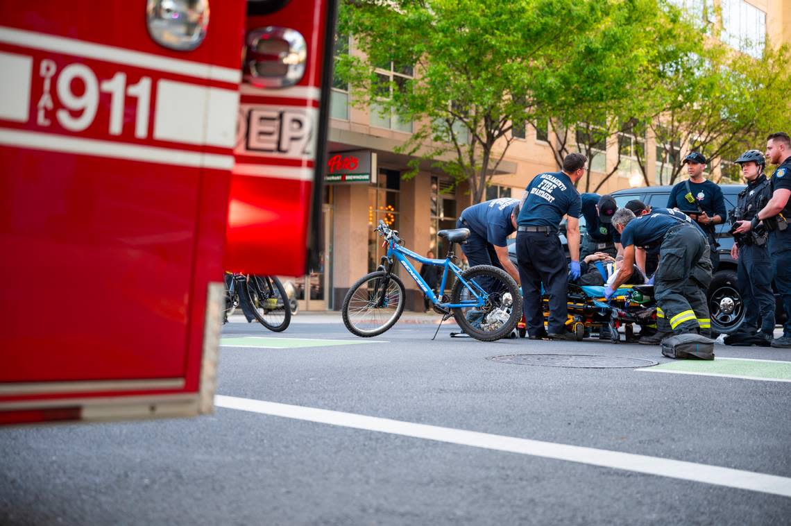 Sacramento firefighters assist a cyclist involved in a nonfatal collision in downtown Sacramento on April 2, 2024. Nathaniel Levine/nlevine@sacbee.com