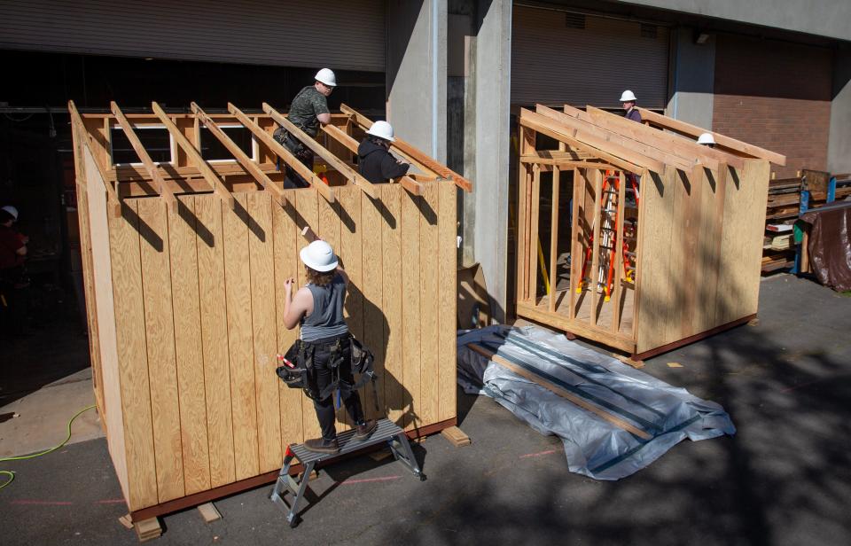 Students work on a pair of storage sheds with Eugene School District 4J’s Constructing a Brighter Future program.