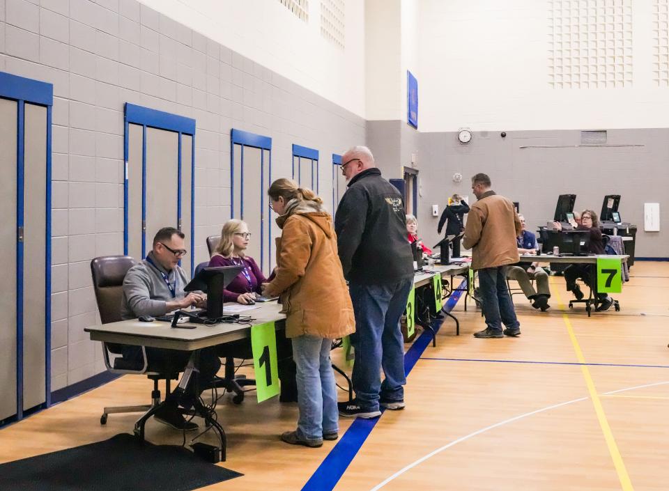 Poll workers assist voters at Rolling Hills Elementary School polling station in Mukwonago on April 2. Voters in the Mukwonago Area School District rejected $102.3 million referendum aimed at building a new middle school to replace the existing Park View Middle School, which was built in 1954.