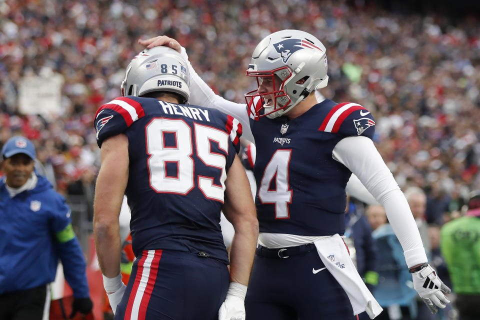 New England Patriots quarterback Bailey Zappe (4) celebrates with tight end Hunter Henry (85) after Henry scored on a pass by Zappe in the first half of an NFL football game against the Kansas City Chiefs, Sunday, Dec. 17, 2023, in Foxborough, Mass. (AP Photo/Michael Dwyer)