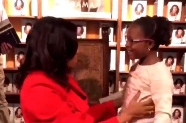 Adorable moment young girl is overcome with excitement as she meets her hero Michelle Obama