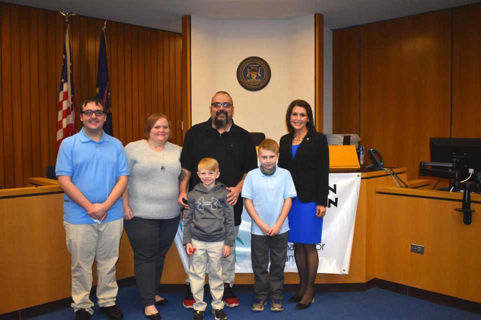 State Rep. Bronna Kahle, R-Adrian, right, was in attendance Monday for Lenawee County's observance of Adoption Day. Held in Probate Judge Catherine A. Sala's courtroom, the family of Brigitte and Dennis Sneyd were granted approval to adopt Brantly, 10, front right, and Seth, 8. Also pictured is the Sneyds' biological son, Joseph, left.