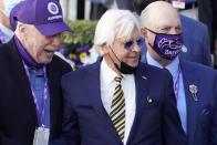 Trainer Bob Baffert, center, and others celebrate Authentic's win who was ridden by John Velazquez in the Breeder's Cup Classic horse race at Keeneland Race Course, in Lexington, Ky., Saturday, Nov. 7, 2020. (AP Photo/Michael Conroy)