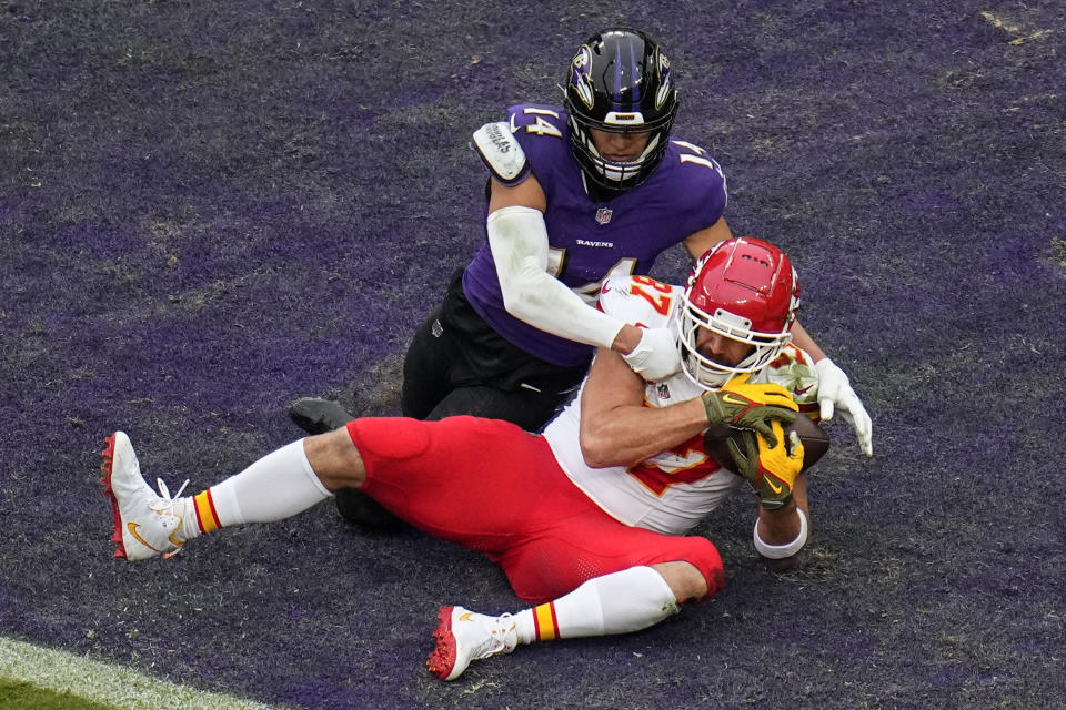 Kansas City Chiefs tight end Travis Kelce (87) makes a touchdown catch in the end zone against Baltimore Ravens safety Kyle Hamilton (14) during the first half of an AFC Championship NFL football game, Sunday, Jan. 28, 2024, in Baltimore. (AP Photo/Julio Cortez)